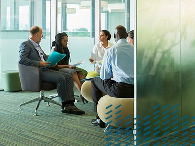 group at office sitting in circle, modern chars, glass wall